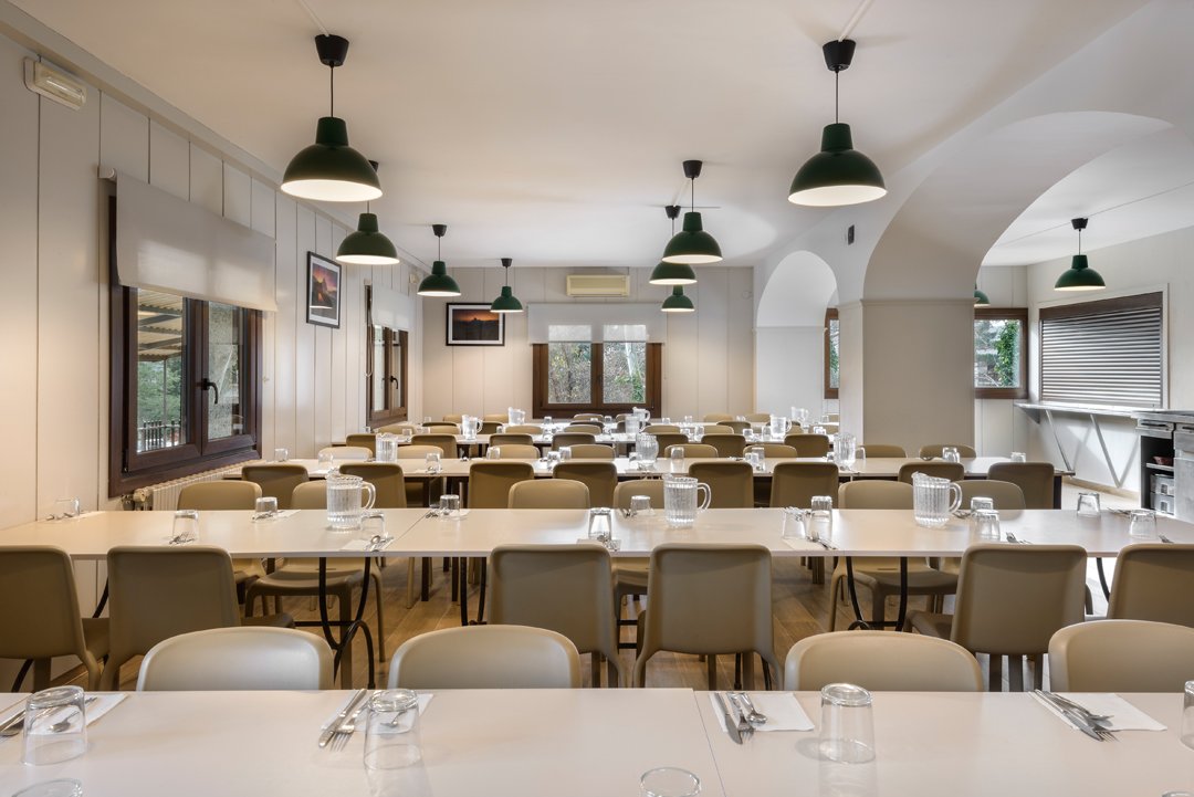 Comedor del albergue con mesas puestas
