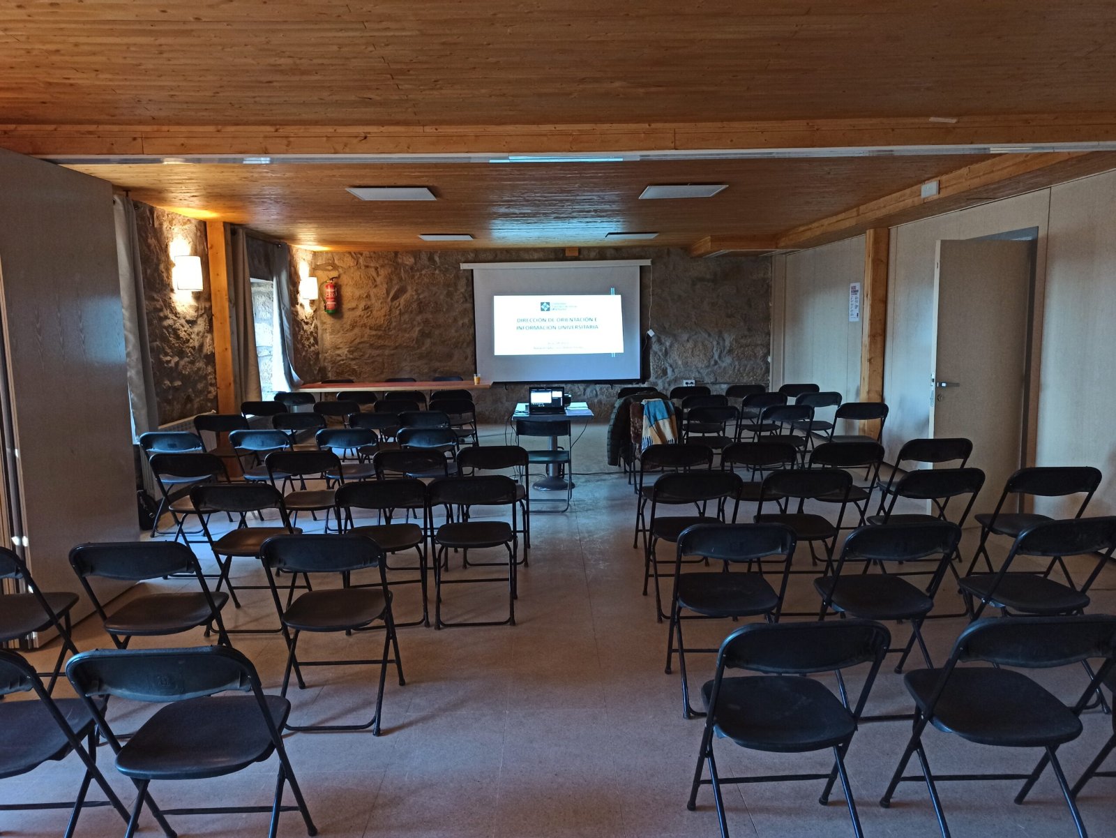 Sala con sillas y pantalla de proyección